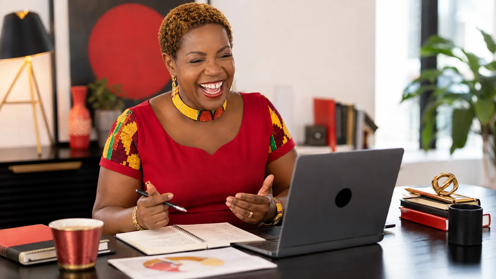 Lily Naadu Mensah reviewing a personal brand profile at her desk